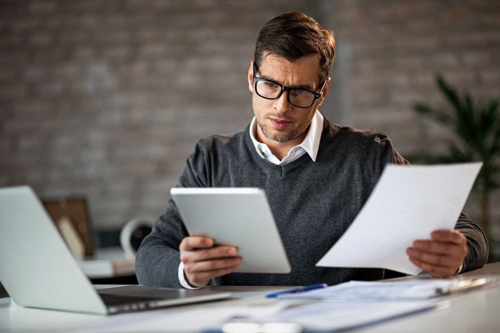 Businessman in a modern office reviews his paperwork