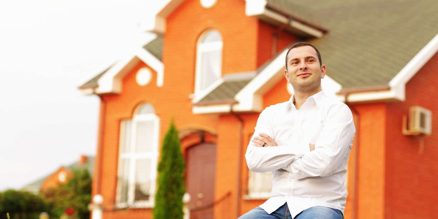 Satisfied man outside house