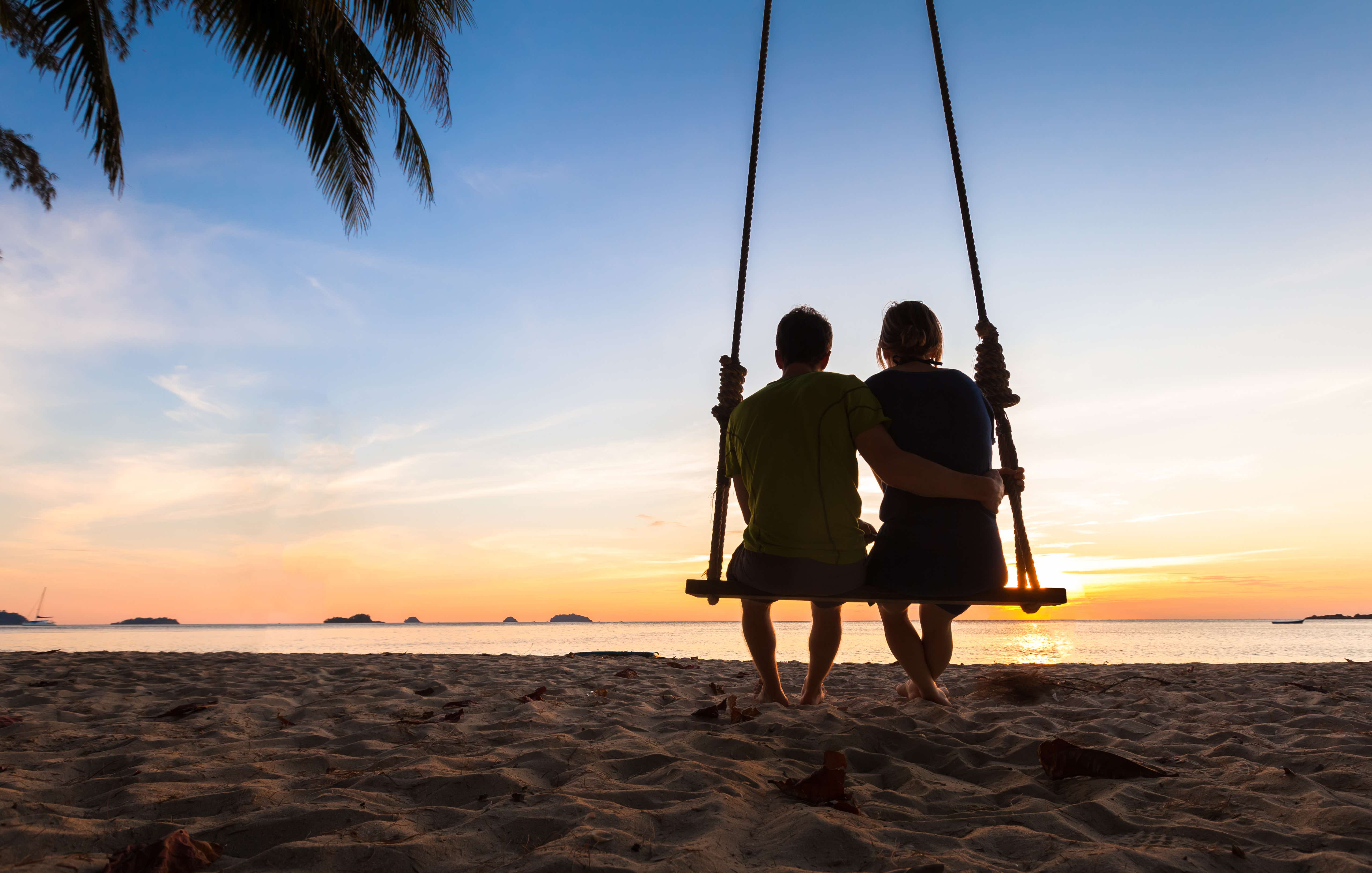 Couple on paradise beach resort sharing honeymoon