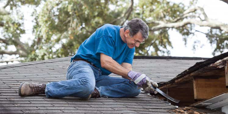 man-on-roof-fixing-tiles