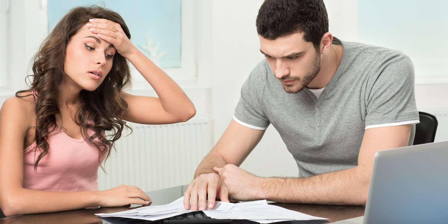 Stressed couple looking at bills