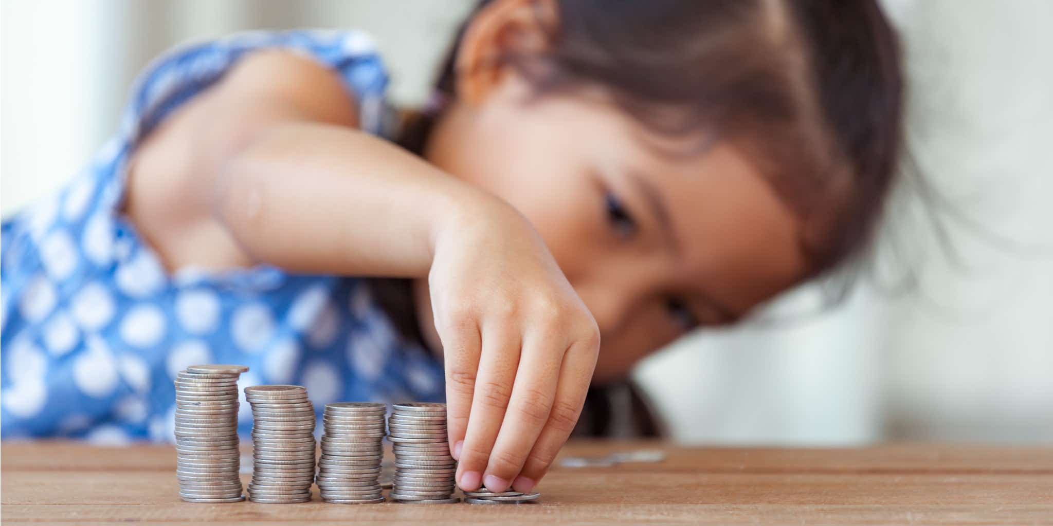 Young girl counting coins