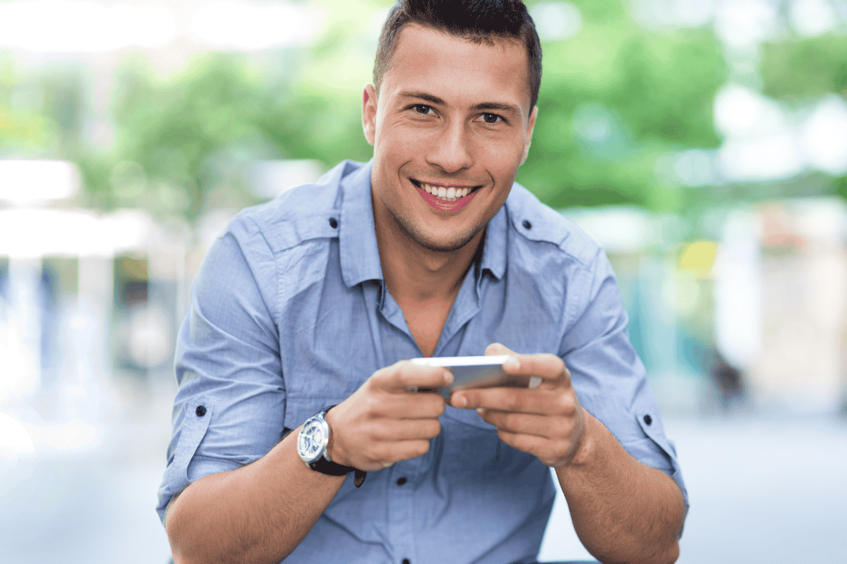 Young man with smartphone outdoors