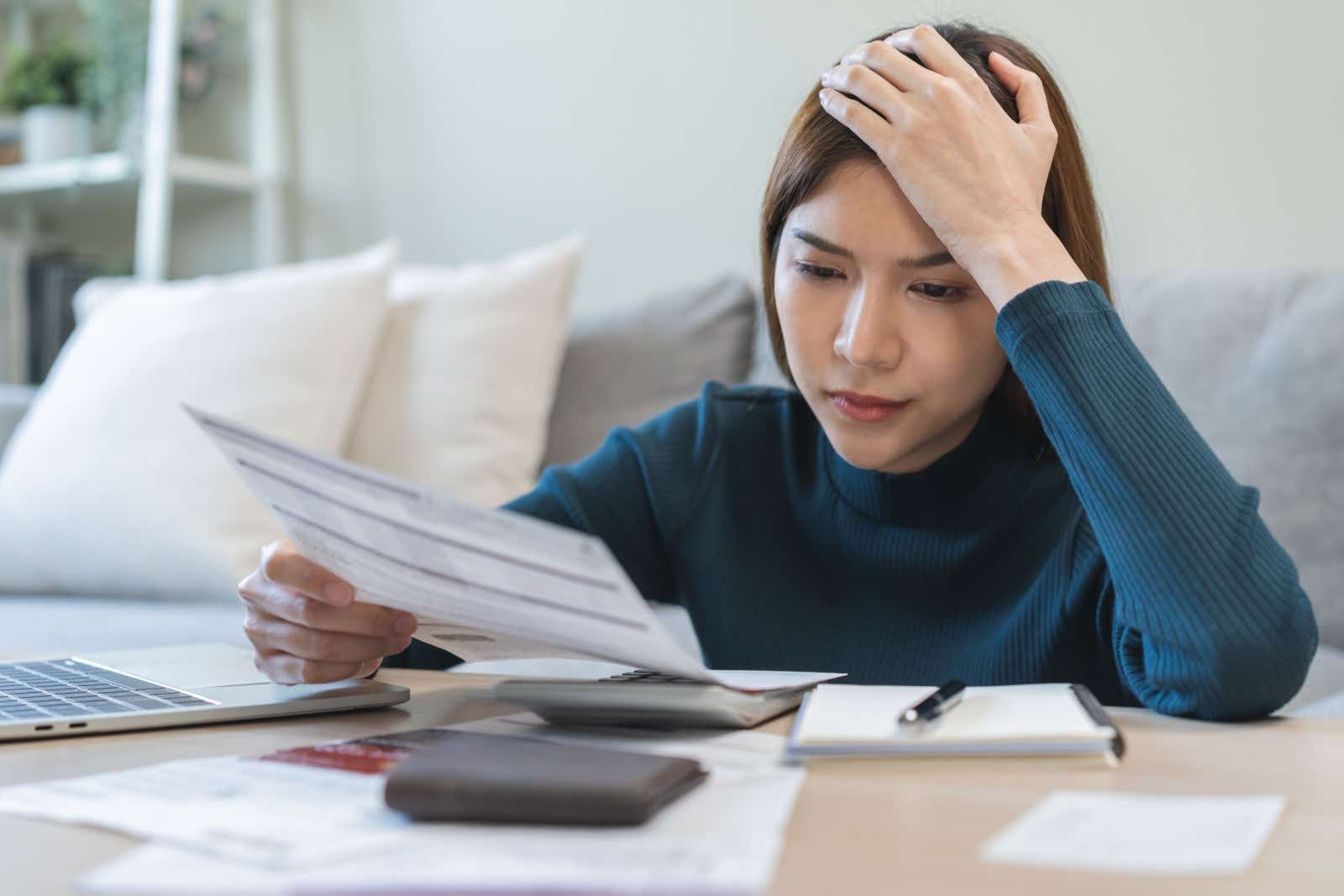 Worried businesswoman checks her finances
