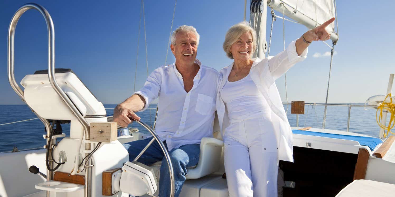 happy-senior-couple-at-the-wheel-of-boat