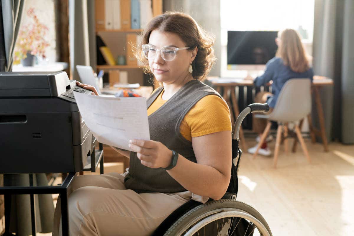 Woman in a wheelchair checking paperwork